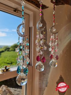 three wind chimes hanging from the side of a window