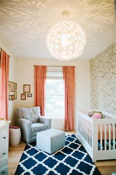 a baby's room with orange curtains and a white crib