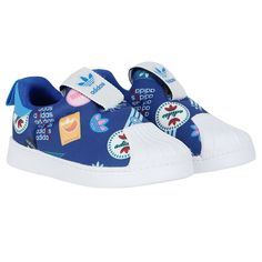 Blue Adidas kids' sneakers with colorful logo patterns and white shell toes. Blue Panels, Colorful Logo, Logo Color, Boys Shoes