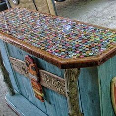 an old wooden box with many different colored buttons on it's lid and sides