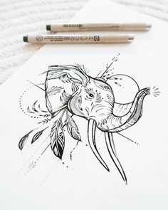 a drawing of an elephant with feathers on it's head and some pencils next to it