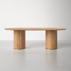 an oval wooden table on a white floor