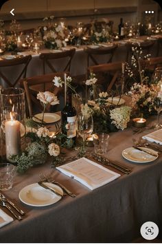 the table is set with place settings, candles and napkins for an elegant dinner