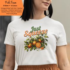 Introducing our "Just Squeeze" Shirt--a fun and vibrant vintage tee that's sure to brighten your day! Featuring a mouth-watering  graphic of juicy oranges on their vines and lush leaves, this shirt is a delightful nod to all things fresh and fruity. Perfect for anyone who loves a playful, retro style, this "Just Squeeze" shirt adds a splash of citrusy fun to any outfit. Squeeze the day with a smile! Bella And Canvas Brand Shirts (Lightweight) Unisex Adult Sizing (Not Fitted To One Gender) Photos in listing are Bella And Canvas brand, but for Demo purposes only as we do not hold inventory. Items are made to order. Props used in photos are NOT included with purchase. We do our best to accurately display the product in listing photos. As we do not hold inventory and products are made to order Fruit Shirt, Orange Tees, Cottagecore Shirt, Orange T Shirts, Orange Shirt, Gardening Shirts, Branded Shirts, Vintage Summer, Summer Tshirts