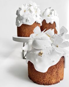 two cakes with white frosting and flowers on them