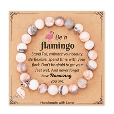 a pink flamingo beaded bracelet with the words be a flamingo on it