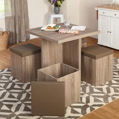 a dining room table with four stools and a white cabinet