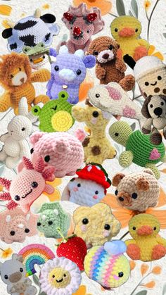 there are many crocheted stuffed animals in this photo together, all different colors and sizes