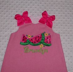 This is a 2 piece set that includes a-line top with applique. Top is completely lined on the inside and buttons at the shoulders. Pants have a comfy elastic waist. Monogramming is included (no additional charge) Bows are pinned on for easy removal and are heat sealed to prevent frayng. Available in your size choice from Newborn up to size 6X. NOTE, CHOICES FOR BOTTOMS: You can choose bloomers, pantaloons (pants style that has the elastic at the bottom), capri/cropped length pants or full length Cute Fitted Gingham Sets, Playful Gingham Sets For Spring, Summer Gingham Sets For Playtime, Summer Gingham Playtime Set, Spring Gingham Sets With Ruffles, Fitted Gingham Sets For Spring, Fitted Gingham Cotton Sets, Cute Gingham Sets For Summer, Cute Gingham Sets For Playtime