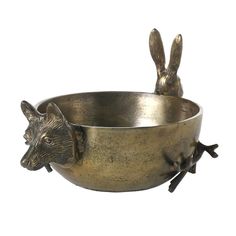 a metal bowl with two rabbits in it