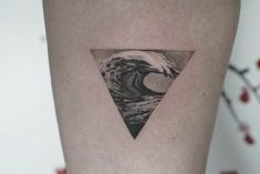 a triangle tattoo with a wave in it