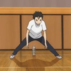 a man standing on top of a wooden floor in front of a basketball court with a ball