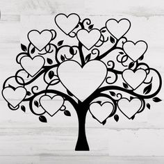 a black and white tree with hearts cut out of it's branches on a wooden background