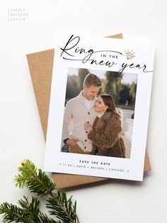 a christmas card with an image of a couple hugging and the text, king in the new year save the date