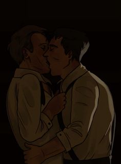 two men kissing each other in the dark