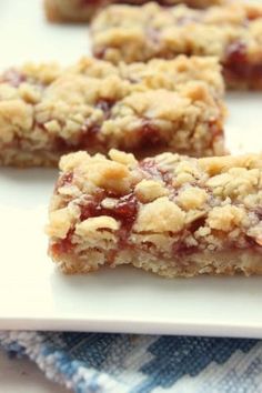 several pieces of fruit and oatmeal bars on a white plate