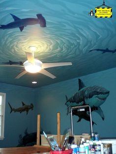 the ceiling is painted with shark images on it