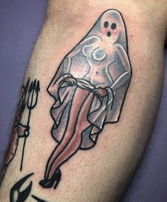 a person with a tattoo on their leg that has an image of a ghost in it