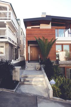 two story houses with balconies and stairs leading up to the front door area