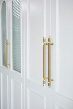 two white doors with gold handles on them