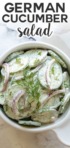 a white bowl filled with cucumber salad on top of a table