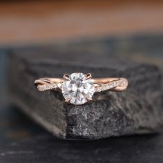 a diamond ring on top of a rock