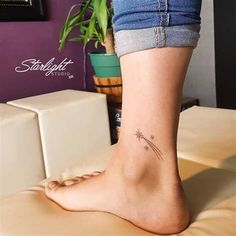 a woman's foot with a small star tattoo on the side of her leg