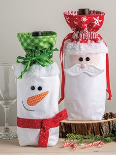 two wine bottles decorated like santa claus and snowman