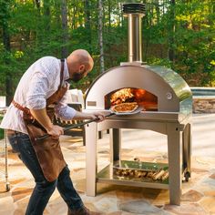 a man is cooking food in an outdoor oven