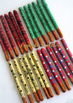 many different colored candles are lined up on a white counter top with stars and stripes