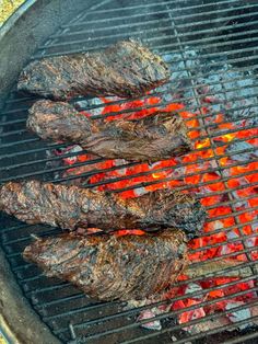 steaks cooking on the grill with red hot peppers