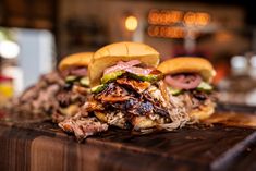 two pulled pork sandwiches on a cutting board