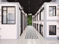 a long hallway with black and white tiles on the floor