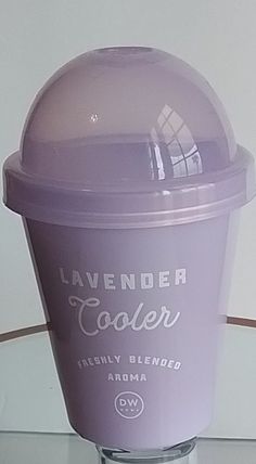 a lavender colored ice cream is sitting on a glass table top with the words lavender cooler above it