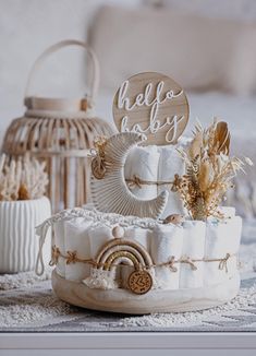 a baby shower cake sitting on top of a table next to a birdcage