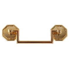 a pair of gold metal handles on a white background