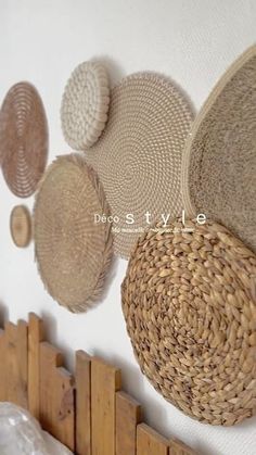 there are many woven baskets hanging on the wall