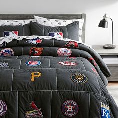 a baseball themed comforter set on a bed