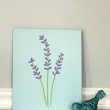 a blue vase with purple flowers sitting on top of a shelf next to a painting