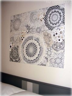 an art piece made out of crocheted doily and buttons on a wall