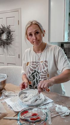 a woman is making some food on the table