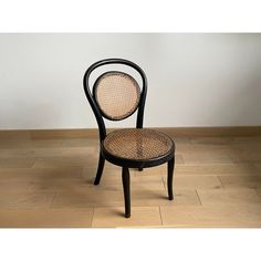 a black chair sitting on top of a hard wood floor