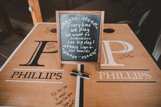 a wooden table topped with a chalkboard sign