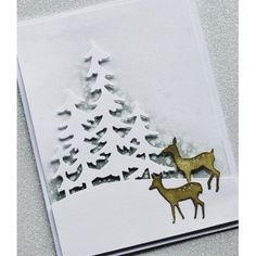 a card with two deer in the snow