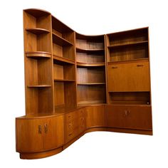 a curved wooden bookcase with drawers and cupboards