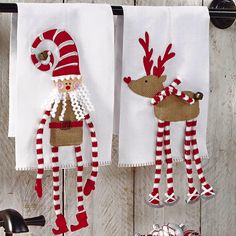 three christmas towels hanging on the wall