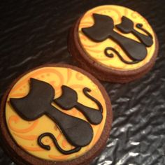 two decorated cookies sitting on top of a table