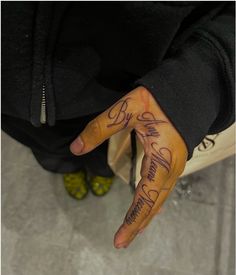 a person's hand with some writing on it