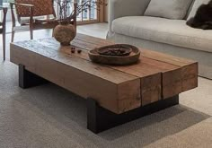 a dog laying on the floor in front of a couch and coffee table with a bowl on it