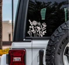 a white flower sticker is on the back of a truck's tailgate